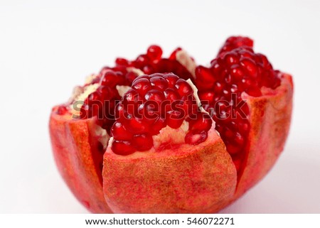 peeled pomegranate fruit closeup on white background