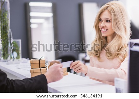 Smiling woman is looking at receptionist