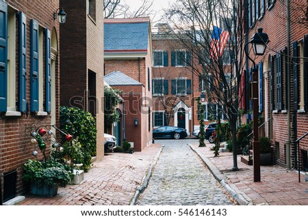 Historic brick houses and narrow cobblestone alley in Society Hill, Philadelphia, Pennsylvania.