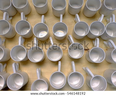 white mugs arranged on the table look to orderly beautiful.