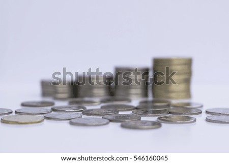 Coin put on the floor with stack of coin in background