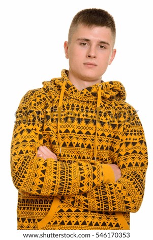 Close up of young Caucasian man with arms crossed isolated against white background