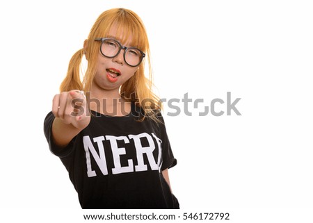 Young happy Asian nerd woman smiling while wearing underwear and pointing finger isolated against white background