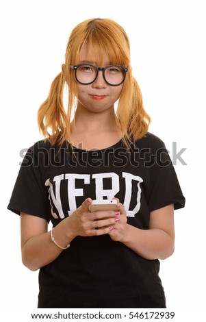 Young cute Asian nerd woman using mobile phone isolated against white background