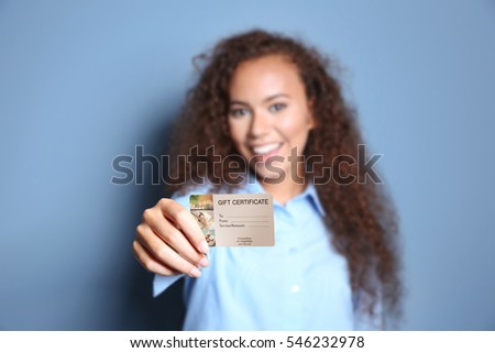 Holiday celebration concept. Woman showing spa service gift certificate