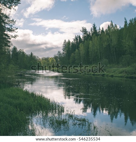 Summer river with reflections in Gauja National Park in Latvia - instant vintage square photo