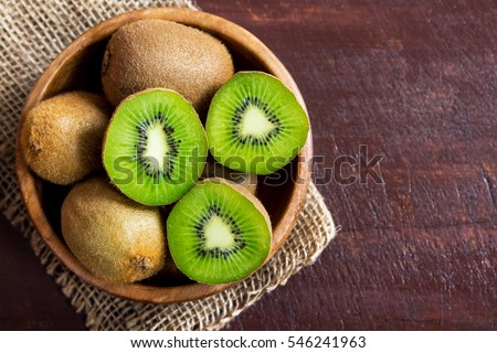 Kiwi fruit on wooden background with copy space Royalty-Free Stock Photo #546241963