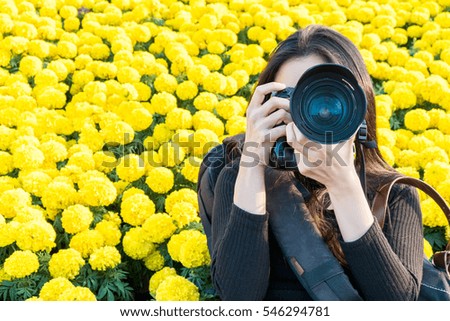 photographer taking photo on flower background, selective focus