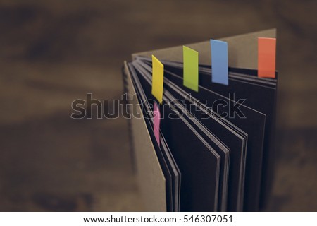 Abstract notebook with color note tab. Notebook with colors note tab on wooden table background, Vintage picture tone.
 Royalty-Free Stock Photo #546307051