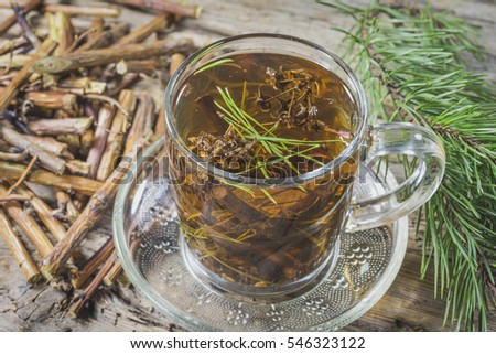 Useful tea from dry branches raspberries and pine needles Royalty-Free Stock Photo #546323122
