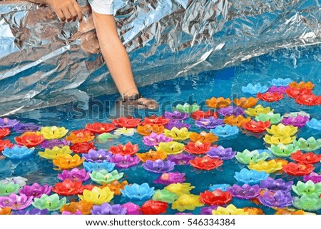 praying by floating colorful flower-shaped candles as Buddhism ritual