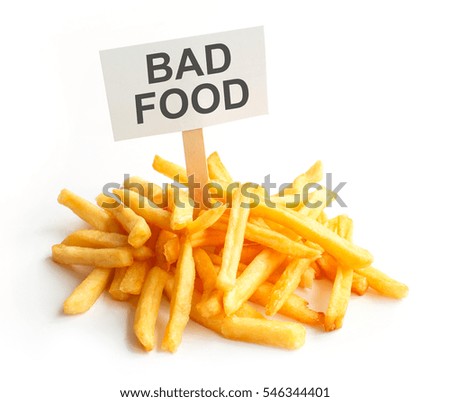 Pile of potato fries on kraft paper. Poor street food, obesity, heart disease. French fries with a sign, Empty copy space for text
