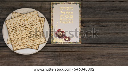 White plate  with matzah or matza and Passover Haggadah on a vintage wood background presented as a Passover seder feast or meal with copy space. Perfect for your Passover design.
 Royalty-Free Stock Photo #546348802