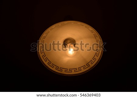 Bulb in an old ceiling on a black background