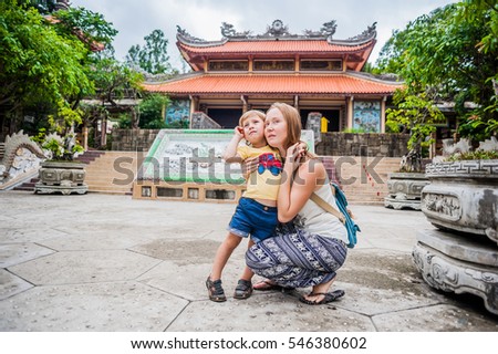 Happy tourists mom and son in Long Pagoda. Travel to Asia concept. Traveling with a baby concept.