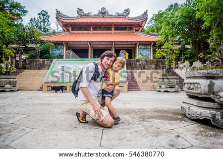 Happy tourists dad and son in Long Son Pagoda. Travel to Asia concept. Traveling with a baby concept.
