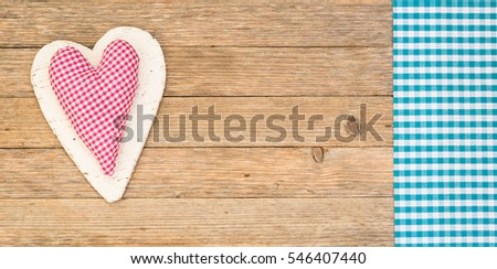 Romantic love background with pink heart on wooden table, top view, copy space.