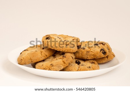 Cookies with raisins on a white plate Royalty-Free Stock Photo #546420805
