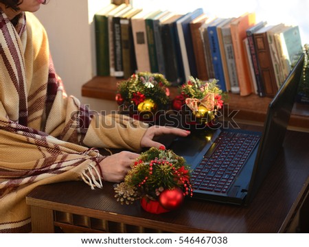 girl in plaid works at the computer