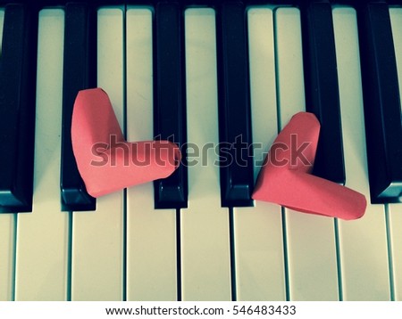 Two Folding paper red hearts on Piano or Keyboard in Retro Color Design.
 You can use for greeting card for Valentine's Day with Text [Happy Valentine's Day]