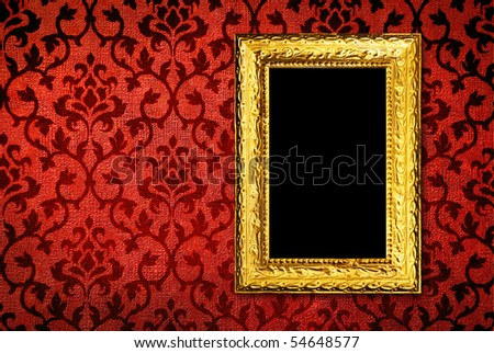 Gold frame on a vintage red wall background