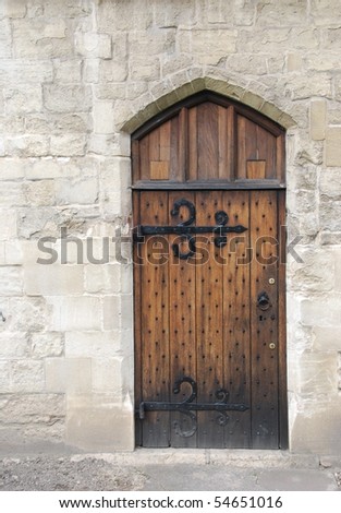 old wooden door from medieval era on stone wall castle architecture