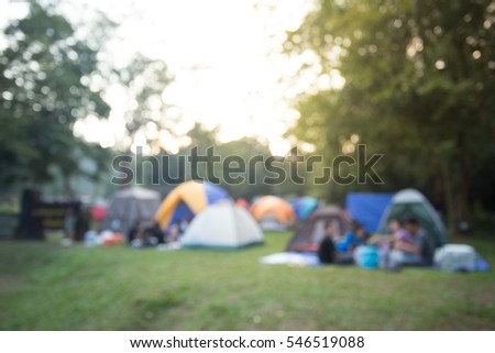 Blurred image Camping and tent under the pine forest in sunset.