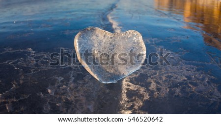 Icy heart in a crack in the light of sunset. lake Baikal.