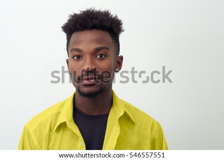 young man portrait yellow shirt studio shot white background