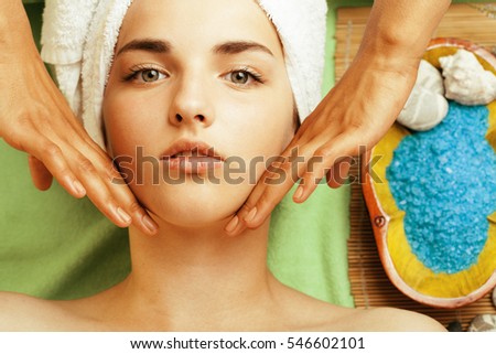 stock photo attractive lady getting spa treatment in salon, close up asian hands on face
