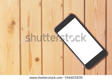 Smart phone with blank screen on wooden table background with copy space for moc up display your product Royalty-Free Stock Photo #546605830