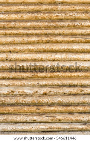 Roundish brown and yellow wooden logs, background