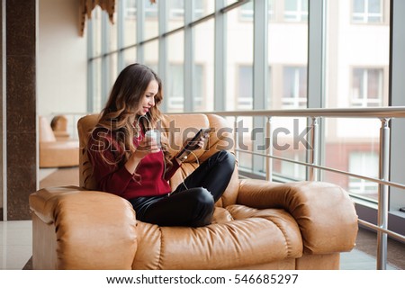 girl listening to music through headphones on the tablet