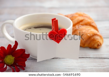 Cup of fresh morning coffee with croissant. Valentine's day concept. Selective focus, horizontal.