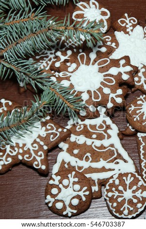 Christmas background with gingerbread. Homemade delicious Christmas gingerbread cookies on the wooden background. Christmas gingerbread cookies with icing.