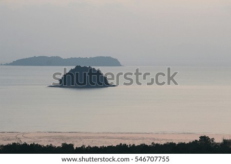 A small island in the sea in the morning before sunrise.