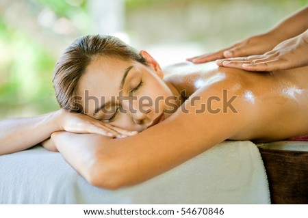 An attractive caucasian woman lying down on a massage bed at a spa Royalty-Free Stock Photo #54670846