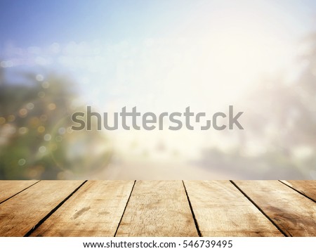 Wood table bar texture front window blurry bokeh outside garden calm view. Summer rustic kitchen stage, breakfast promotion presentation. mosque landscape place grunge spring board, Urban city scape. Royalty-Free Stock Photo #546739495
