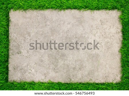 Square concrete plate on artificial green grass background