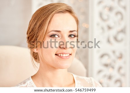 
face blonde happy bride before the wedding.
Portrait of a young girl with a beautiful smile. The bride smiles. Beautiful teeth.