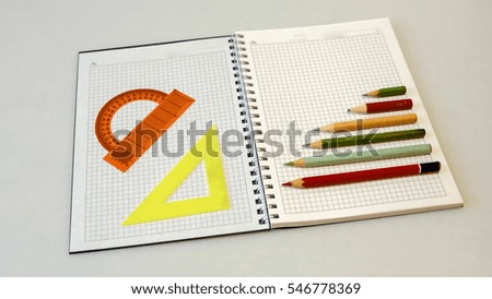 notebook with pencils and rulers on a light background