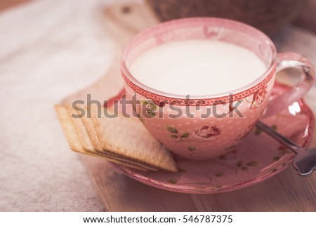 Milk and cookies on wooden background.