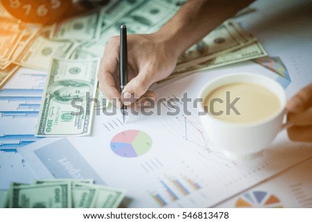 Businessman writing a paperwork with coffee.