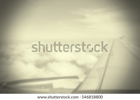 Blurred abstract background and can be illustration to article of Aircraft wing flying and cloud blue sky