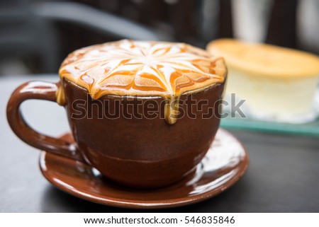 Cup of coffee with caramel on top Royalty-Free Stock Photo #546835846