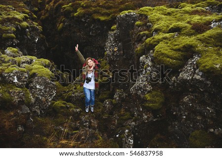 happy photographer woman on stones