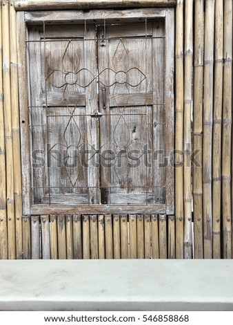 Old Wooden window on bamboo background with copyspace.
