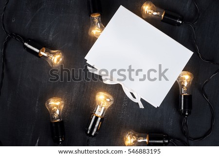 Gift Box and light bulbs to the dark background