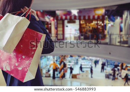 Woman holding shopping bags in the shopping mall
 Royalty-Free Stock Photo #546883993