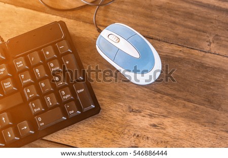 Keyboard and mouse on table in sunlight